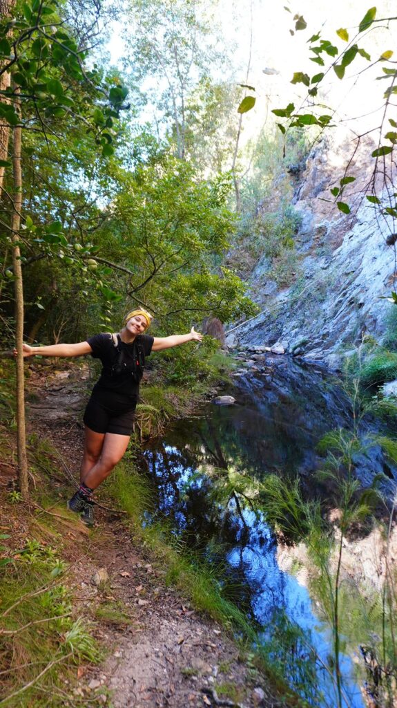 Linda Hikes next to mountain pool Home